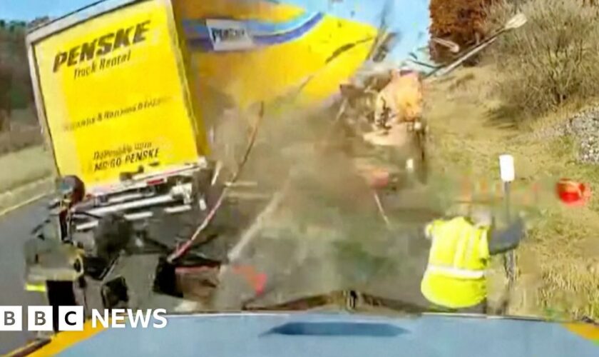 Watch: Moment road worker dodges high-speed truck crash