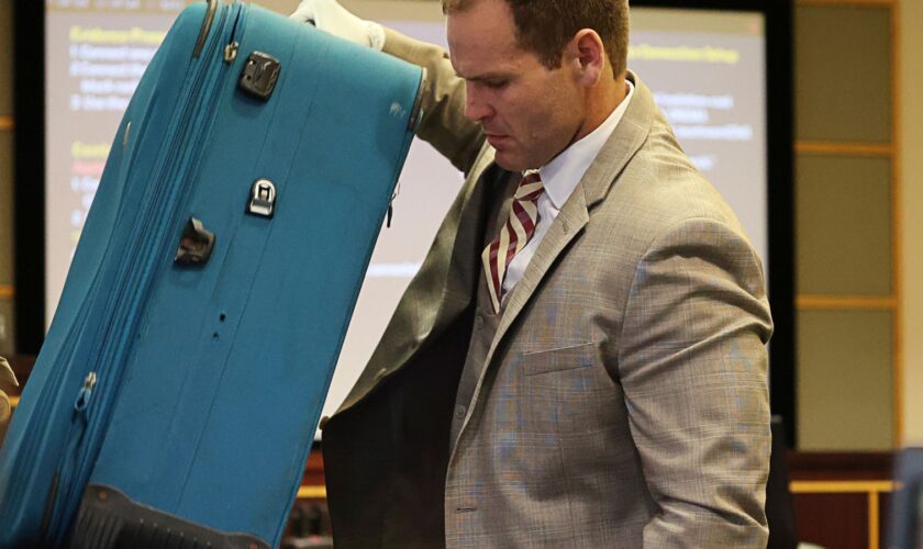 Prosecutor Dave Cacciatore Jr. takes out the suitcase in evidence as he begins the closing arguments in Defendant Sarah Boone's trial, Friday, Oct. 25, 2024, at the Orange County Courthouse in Orlando, Fla. Boone is charged with leaving her boyfriend to die after he was zipped into a suitcase in their home,  (Ricardo Ramirez Buxeda/Orlando Sentinel via AP, Pool)