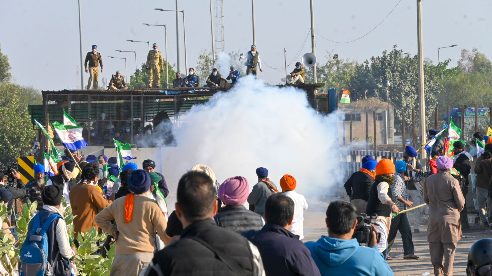 Police fire tear gas to disperse protesting farmers who were marching to New Delhi near the Punjab-Haryana border at Shambhu, India, Friday, Dec. 6, 2024. (AP Photo/Rajesh Sachar)