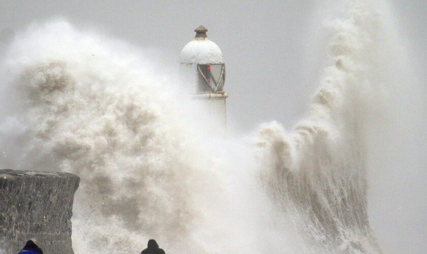 Waves crash over the seafront in Porthcawl in Wales. Millions have been warned to stay indoors, thousands are without power and trains have been cancelled as the Government's "risk to life" alert brought on by Storm Darragh came into force. Picture date: Saturday December 7, 2024. PA Photo. Photo credit should read: Ben Birchall/PA Wire