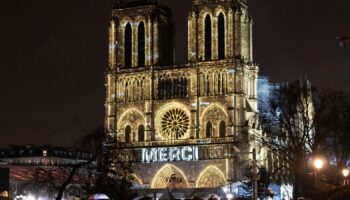 The word 'merci' was projected onto the front of the cathedral. Pic: AP