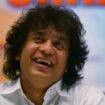 FILE - Indian Tabla expert Zakir Hussain laughs during a press conference to announce a musical concert in Mumbai, India, on Dec 8, 2006. (AP Photo/Rajesh Nirgude, File)