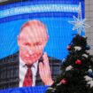 An electronic screen, which shows an image of Russian President Vladimir Putin and a quote from his annual televised year-end press conference and phone-in, is on display on the facade of a building behind a New Year and Christmas tree in a street in Moscow, Russia December 19, 2024. REUTERS/Shamil Zhumatov