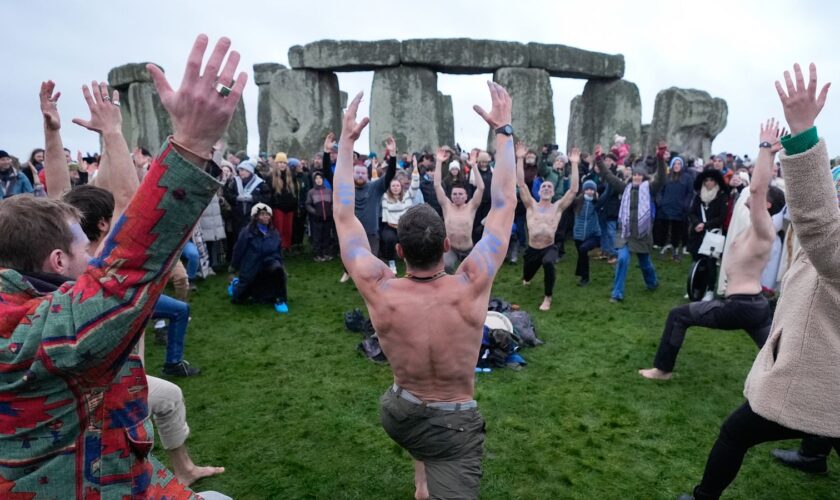 People take part in the winter solstice celebrations during sunrise at the Stonehenge prehistoric monument on Salisbury Plain in Wiltshire. Picture date: Saturday December 21, 2024. PA Photo. See PA story SOCIAL Solstice. Photo credit should read: Andrew Matthews/PA Wire