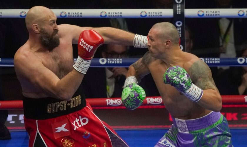 Boxers Britain's Tyson Fury, left, and Ukraine's Oleksandr Usyk compete during their WBA, WBO, and WBC world heavyweight title fight in Riyadh, Saudi Arabia, Saturday, Dec. 21, 2024. (AP Photo/Frank Augstein)