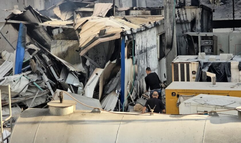 Deux hommes inspectent des dégâts causés par des frappes israéliens à l'extérieur de l'hôpital Kamal Adwan, dans le nord de la bande de Gaza, le 6 décembre 2024