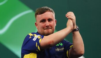 Luke Littler overcomes sticky start to beat Ian White and reach PDC World Championships last 16