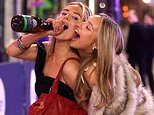 Getting merry! Revellers soak up the festive atmosphere as they head out for office Christmas parties and boozy dos ahead of 'Mad Friday'