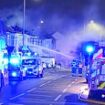 Moment terraced house goes up in flames after massive explosion in London: Sixty firefighters battling to get blaze under control