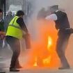 Shocking moment man sets himself on fire in front of stunned police officers in London street after they are called to domestic row