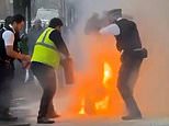 Shocking moment man sets himself on fire in front of stunned police officers in London street after they are called to domestic row