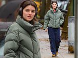 Suri Cruise cuts a casual figure in a khaki coat and cargo pants as she enjoys a stroll around New York City