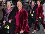 Susanna Reid, 53, gets into the festive spirit in a red velvet suit as she joins youthful mum Sue Smith, 82, for carol concert at Westminster Abbey - after grilling co-host Ed Balls' wife on live TV