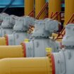 FILE PHOTO: A gas worker walks between pipes in a compressor and distribution station of the Urengoy-Pomary-Uzhgorod gas pipeline, some 30 km (19 miles) from the south western Russian city of Kursk January 4, 2006. REUTERS/Sergei Karpukhin//File Photo