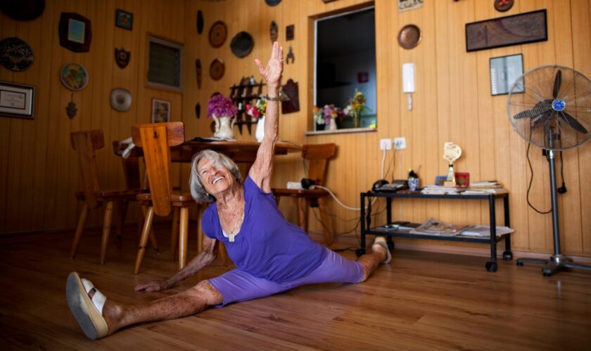 Agnes Keleti, a 91-year-old former Olympic gymnast, performs a split at her house in Herzliya, Israel, Monday, Aug. 13, 2012. Keleti won 10 Olympic medals, including 5 gold medals, while she represented Hungary in the Olympic games of 1948, 1952, and 1956. (AP Photo/Oded Balilty)