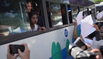 Released prisoners, in a bus, are welcomed by family members and colleagues after they left Insein Prison Saturday, Jan. 4, 2025, in Yangon, Myanmar, as the military government has released more than 6,000 prisoners and has reduced other inmates... sentences as part of a mass amnesty to mark the 77th anniversary of independence from Britain. (AP Photo/Thein Zaw)