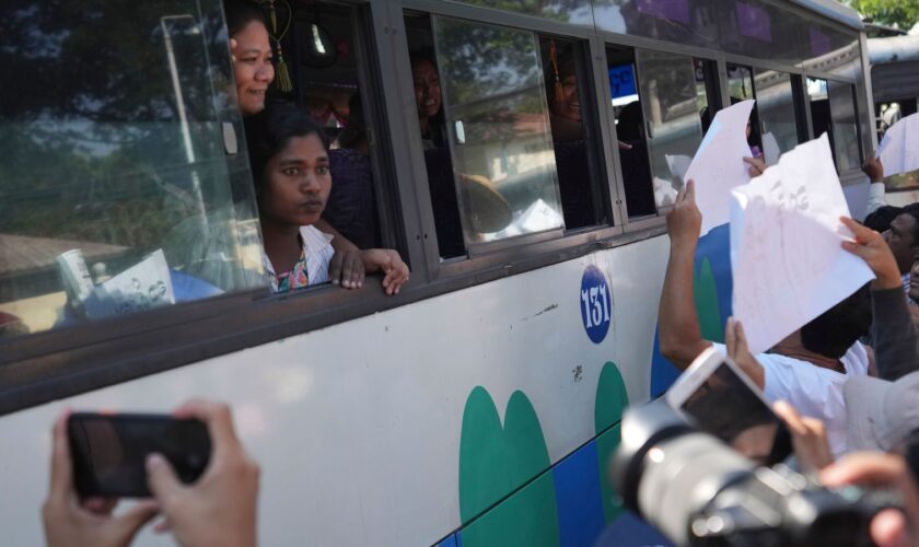 Released prisoners, in a bus, are welcomed by family members and colleagues after they left Insein Prison Saturday, Jan. 4, 2025, in Yangon, Myanmar, as the military government has released more than 6,000 prisoners and has reduced other inmates... sentences as part of a mass amnesty to mark the 77th anniversary of independence from Britain. (AP Photo/Thein Zaw)