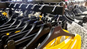 Garments on coat hangers are pictured at a store of clothing retailer Next, in London, Britain, November 17, 2021. Picture taken November 17, 2021. REUTERS/May James