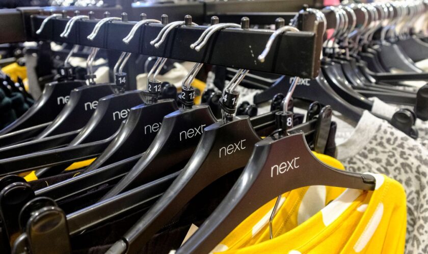 Garments on coat hangers are pictured at a store of clothing retailer Next, in London, Britain, November 17, 2021. Picture taken November 17, 2021. REUTERS/May James