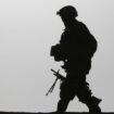 A British soldier is silhouetted as he walks with his machine gun on a roof top of a residential house in the village Qari Sahib, Nad Ali district, Helmend province, southern Afghanistan, Monday, Feb. 15, 2010 (AP Photo/Altaf Qadri)