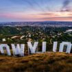 Sunset casts a pink glow over the Los Angeles skyline as seen from behind the famous Hollywood sign Wednesday evening, March 8, 2023. The 95th annual Academy Awards will be held Sunday at the Dolby Theatre in the Hollywood section of Los Angeles. (AP Photo/J. David Ake)