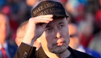 FILE - Tesla and SpaceX CEO Elon Musk listens as Republican presidential nominee former President Donald Trump speaks at a campaign event at the Butler Farm Show, on Oct. 5, 2024, in Butler, Pa. (AP Photo/Alex Brandon, File)