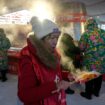 AP PHOTOS: Warm clothing, hot pot and even ice cream bars feature at China's Harbin ice fair