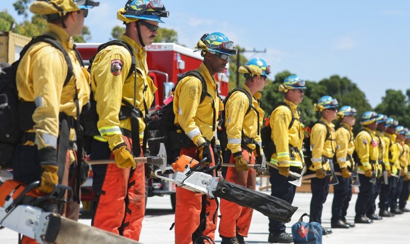 CAMARILLO, CALIFORNIA - JULY 14: Cadets, who were formerly incarcerated, stand with wildland firefighting equipment at the Ventura Training Center (VTC) during an open house demonstration for media and prospective participants on July 14, 2022 in Camarillo, California. The program was developed in 2018 to take formerly incarcerated people, who previously battled fires as California Department of Corrections and Rehabilitation (CDCR) inmate camp members, and train them for a career as professional firefighters. As climate change has stoked increased wildfire behavior in California, there is a surge in demand for trained wildland firefighters across the state. Participants are carefully screened before being accepted to the free 18-month program where they receive a monthly stipend, health insurance, life coaching and mentorship in an effort to reduce recidivism.   Mario Tama/Getty Images/AFP (Photo by MARIO TAMA / GETTY IMAGES NORTH AMERICA / Getty Images via AFP)