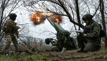 Servicemen of artillery crew of the special unit National Police fire a D-30 howitzer towards Russian troops at a position in a front line, amid Russia's attack on Ukraine, in Zaporizhzhia region, Ukraine January 11, 2025. REUTERS/Stringer