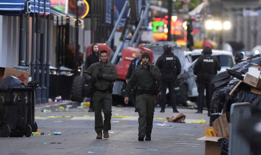 Emergency services attend the scene after a vehicle drove into a crowd on New Orleans' Canal and Bourbon Street, Wednesday Jan. 1, 2025. (AP Photo/Gerald Herbert)