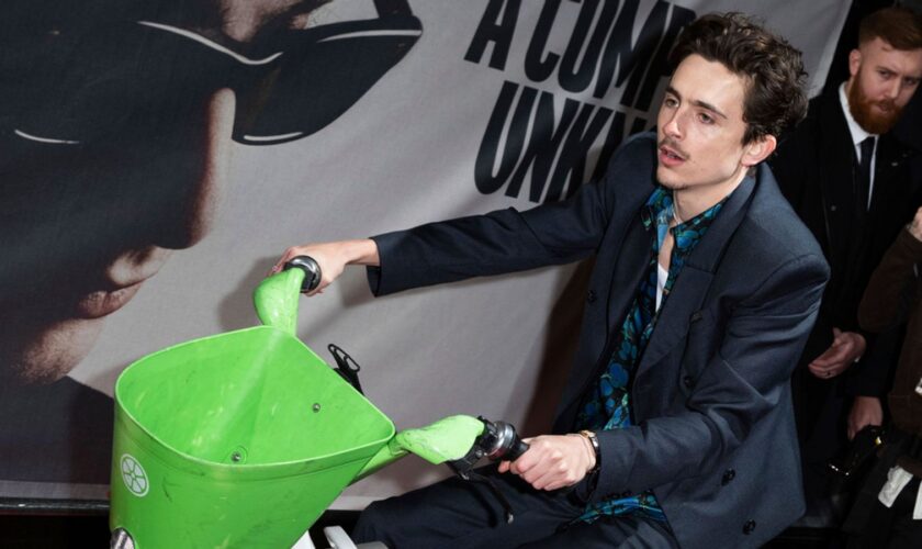 Timothee Chalamet rides an electronic bicycle upon arrival at the premiere of the film 'A Complete Unknown' in London, on Tuesday, Jan. 14, 2025. (Photo by Scott A Garfitt/Invision/AP)