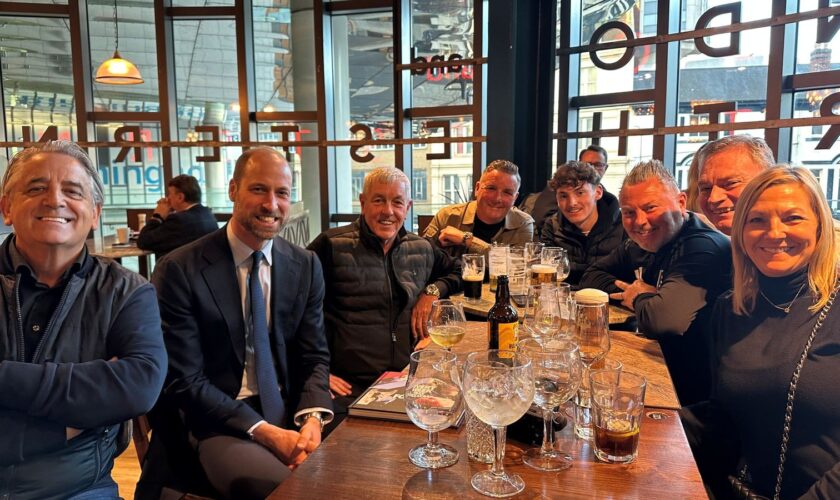 Prince William, second from left, with Aston Villa fans in Wetherspoons. Pic: PA