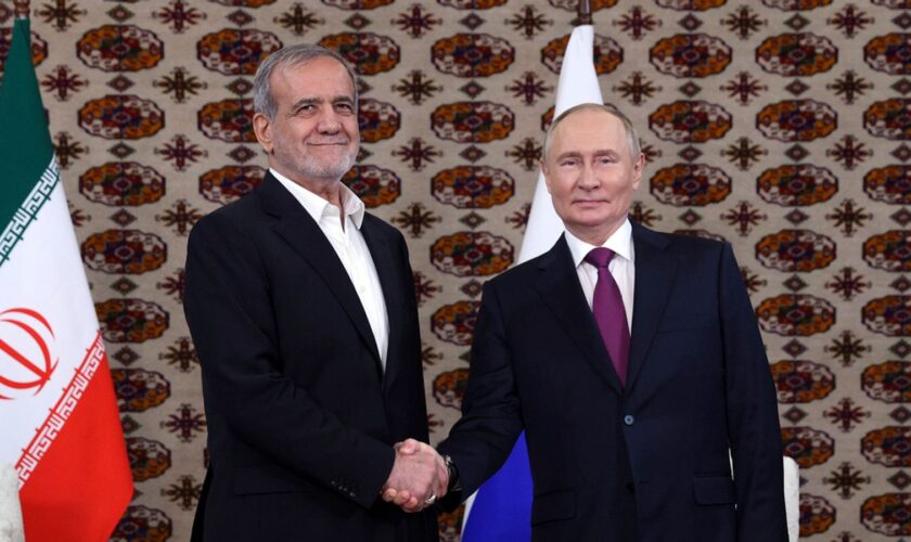 Russian President Vladimir Putin, right, and Iranian President Masoud Pezeshkian shake hands during a meeting in Turkmenistan last year. Pic: AP