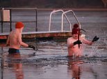 Britain suffers new coldest January night for 15 years as temperature plunges to -19C and weather is so cold wild swimmers have to break the ice for a dip