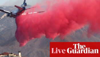 California fires live: progress made against some LA blazes but thickening smoke prompts ‘health emergency’