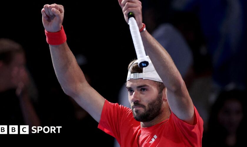 Jacob Fearnley holds his arms aloft after winning his Australian Open second-round match