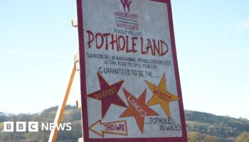 Fed up villagers turn pot holes into attraction