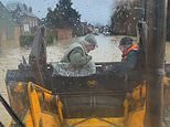 Moment heroic grandson rescues grandparents from their flooded home by carrying them in the bucket of his digger