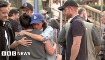 Prince Harry and Meghan hug residents in Pasadena