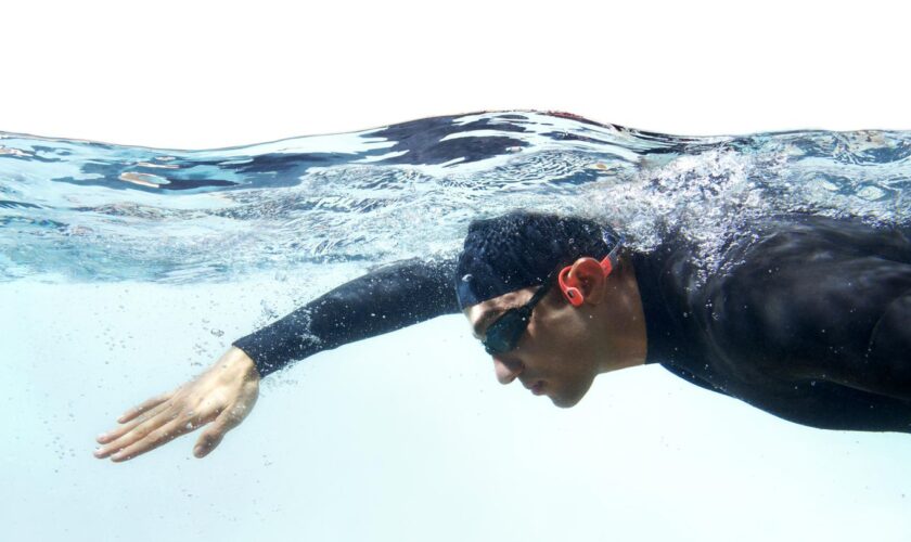 Wasserdichte Kopfhörer: Schwimmer in Neoprenanzug mit Kopfhörern