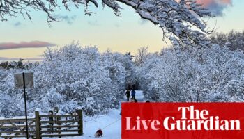 UK weather warnings remain in place as UK hit by snow and freezing rain – live updates