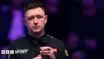 Kyren Wilson chalks his cue