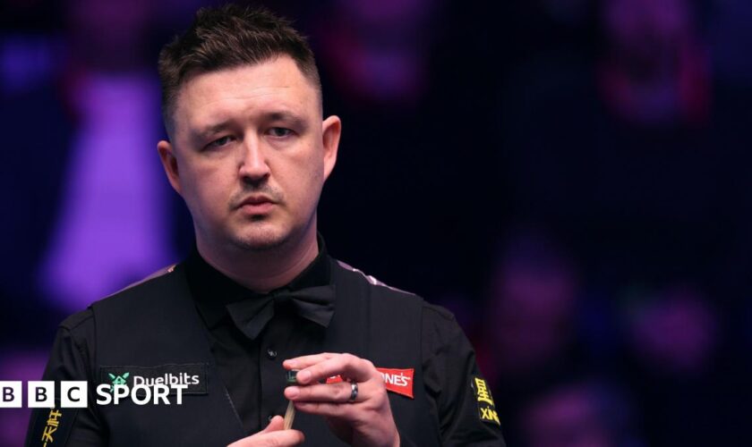 Kyren Wilson chalks his cue